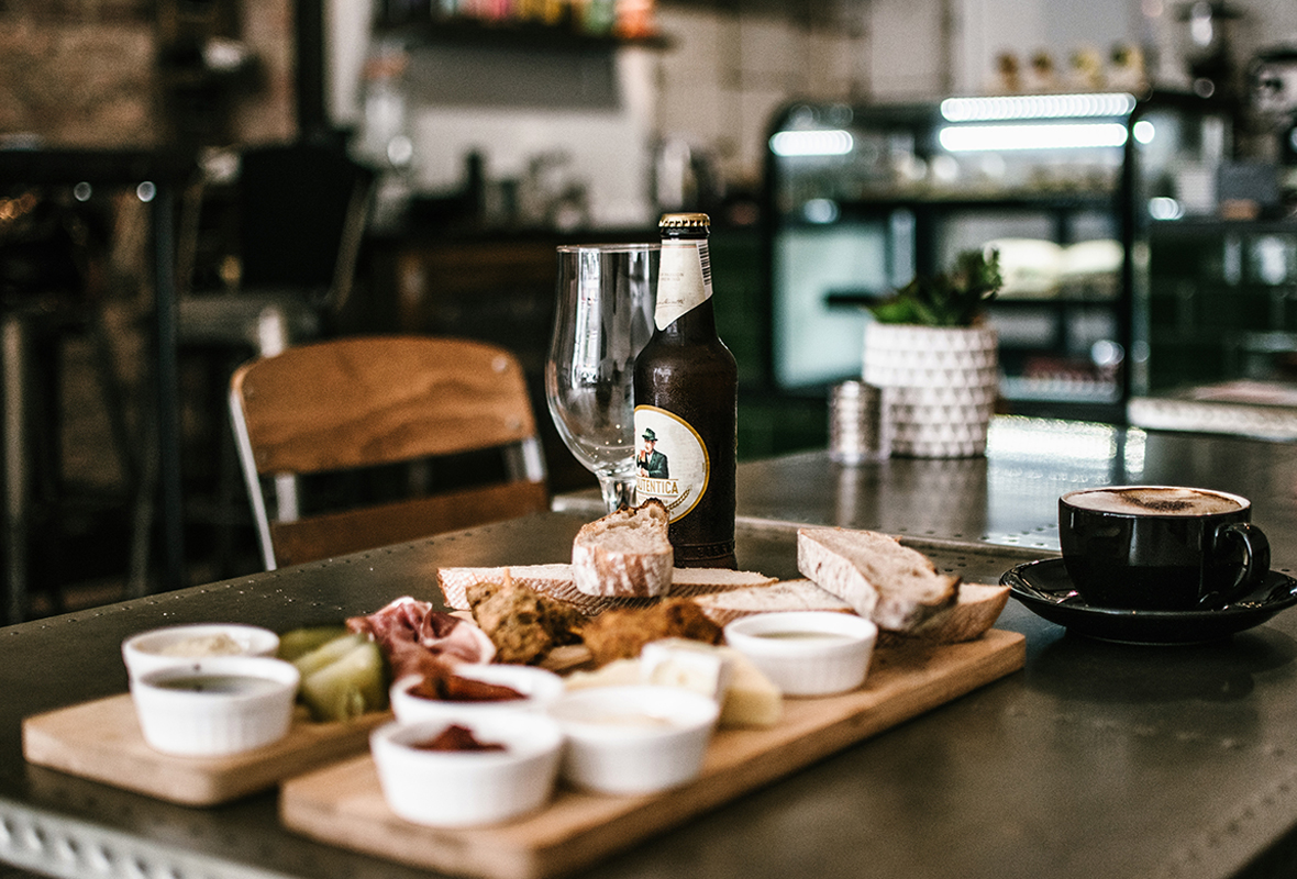 Indulge in a mouth-watering assortment of food and drinks laid out on this table