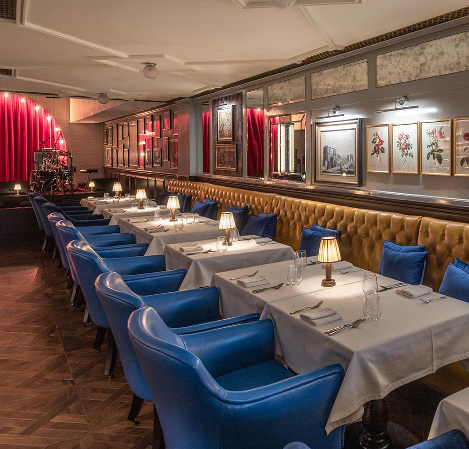 A glimpse of restaurant having blue chairs and white table